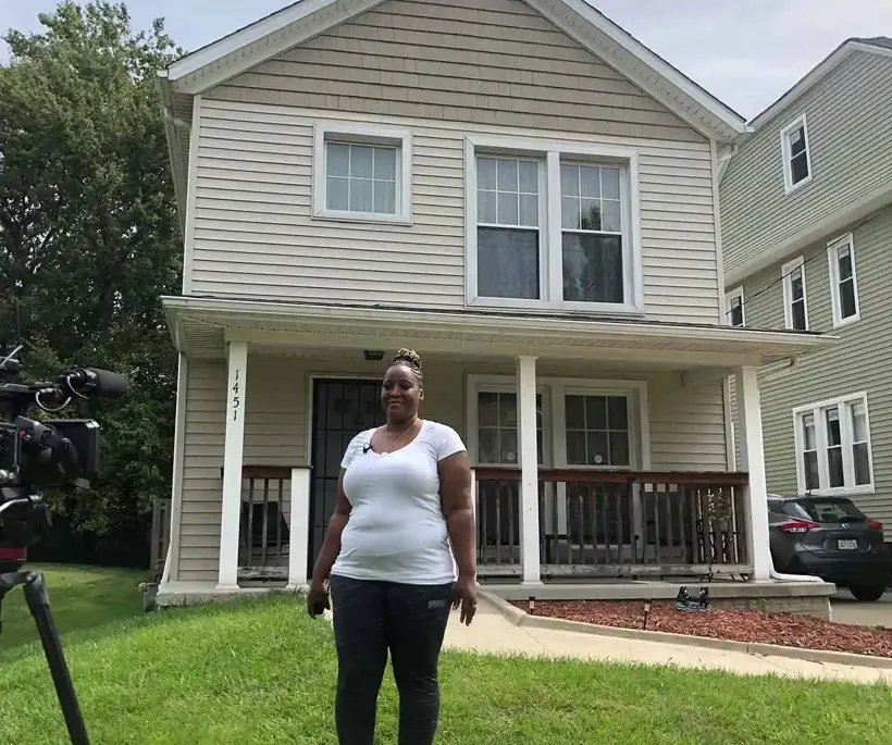 woman in front of house