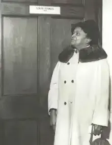 Louise in front of her son Louis’ first Congressional office.
