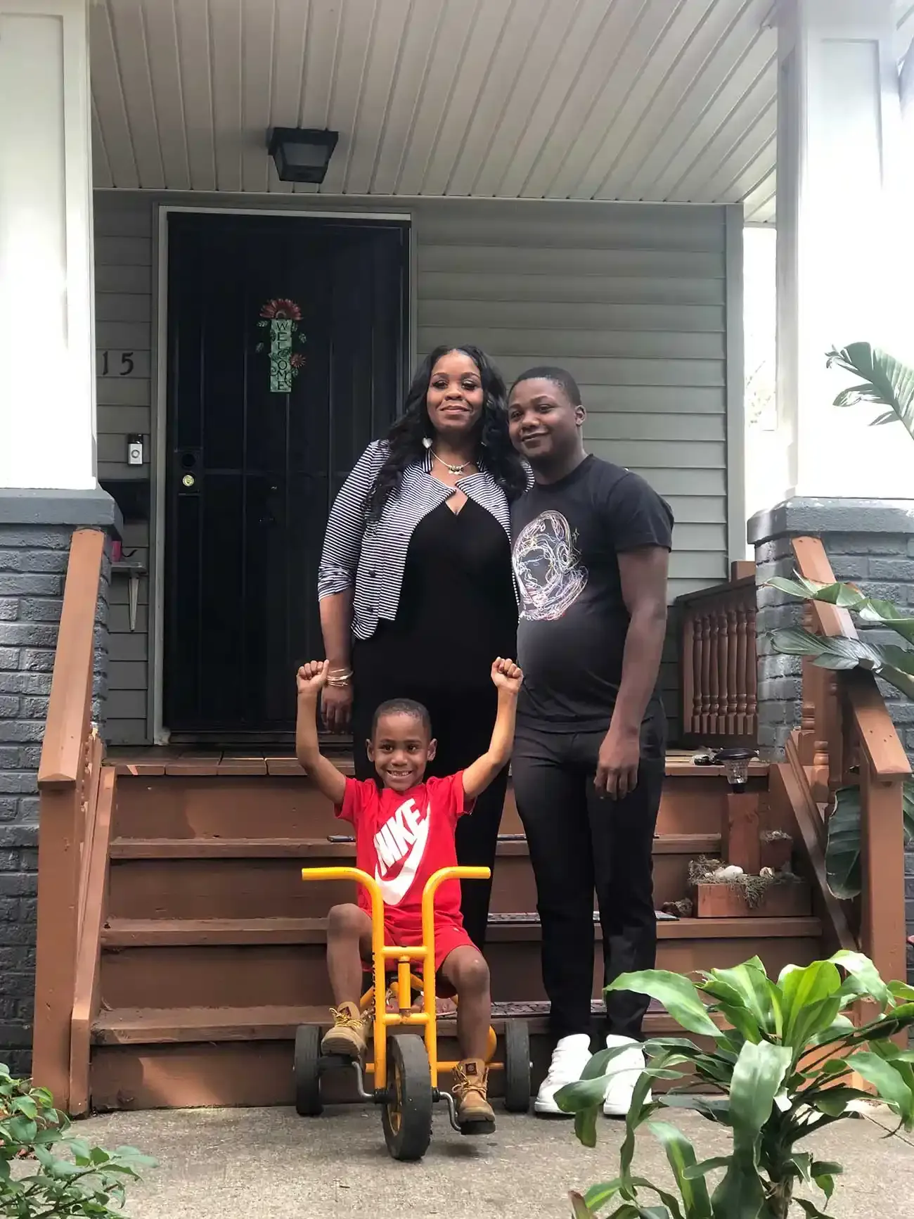 family in front of home