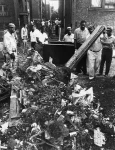 Hough residents clean up on East 73rd street after the 1966 Uprising. Courtesy of Cleveland Memory Project.