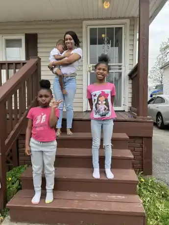 mother and children on house porch