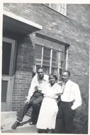 Carl, Louise and Louis in front of Outhwaite Homes where the family lived.