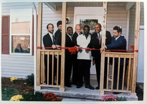Ribbon cutting with Councilman Anthony Brancatelli, Mark McDermott, Mayor Michael White, Congressman Louis Stokes, and unidentified partners from HUD and Slavic Village Development (CHN Archives).